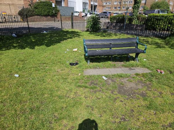 Lots of litter around the bench in the corner-Burr Road, Southfields, London