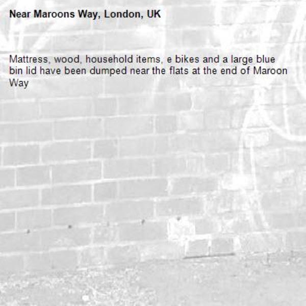 Mattress, wood, household items, e bikes and a large blue bin lid have been dumped near the flats at the end of Maroon Way-Maroons Way, London, UK