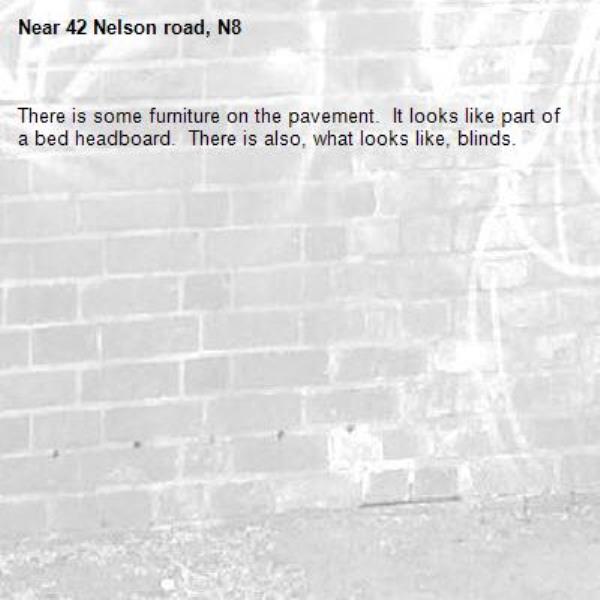 There is some furniture on the pavement.  It looks like part of a bed headboard.  There is also, what looks like, blinds.-42 Nelson road, N8