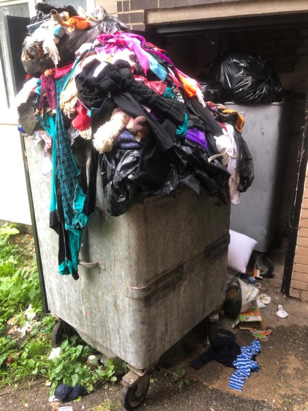 Communal bin overflowing with clothes. Not sure if this bin is meant to go here as it doesn’t fit in the store-51 Bamburgh Close, Reading, RG2 7UD