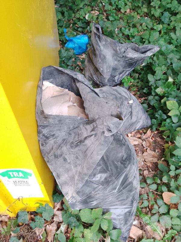 Bags of plasterboard fly tipped beside charity bins on Bridge Road Aldershot-12 Bridge Road, Aldershot, GU11 3DD