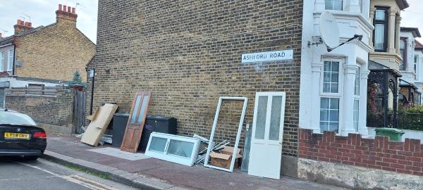 Discarded window frames and doors, close to the junction of Ashford Rd with Burges Rd.-2 Ashford Road, East Ham, London, E6 2AW