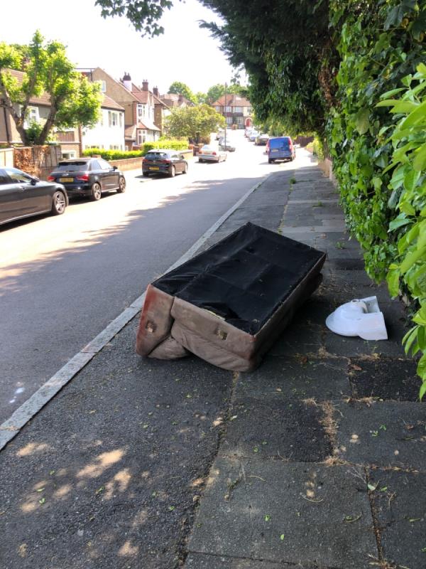 Fly tipped sofa and washbasin blocking pavement-25 Fairlie Gardens, London, SE23 3TE