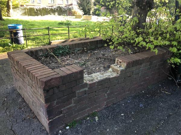 Please repair damaged planter at  front of block-Clairville Point, Dacres Road, London, SE23 2PA