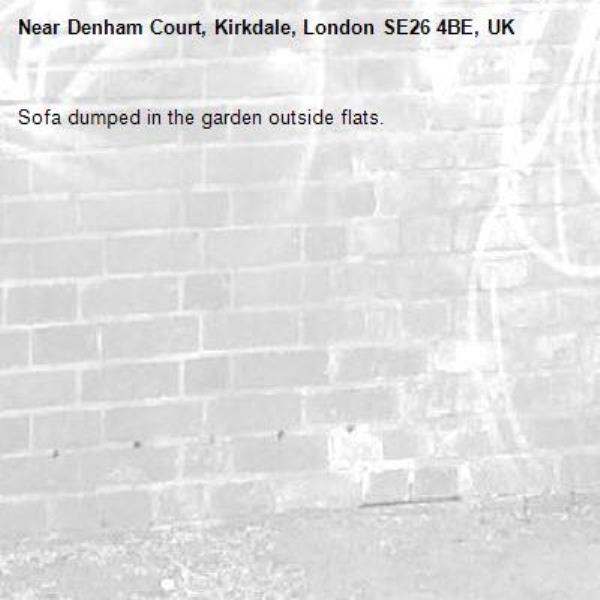 Sofa dumped in the garden outside flats.-Denham Court, Kirkdale, London SE26 4BE, UK