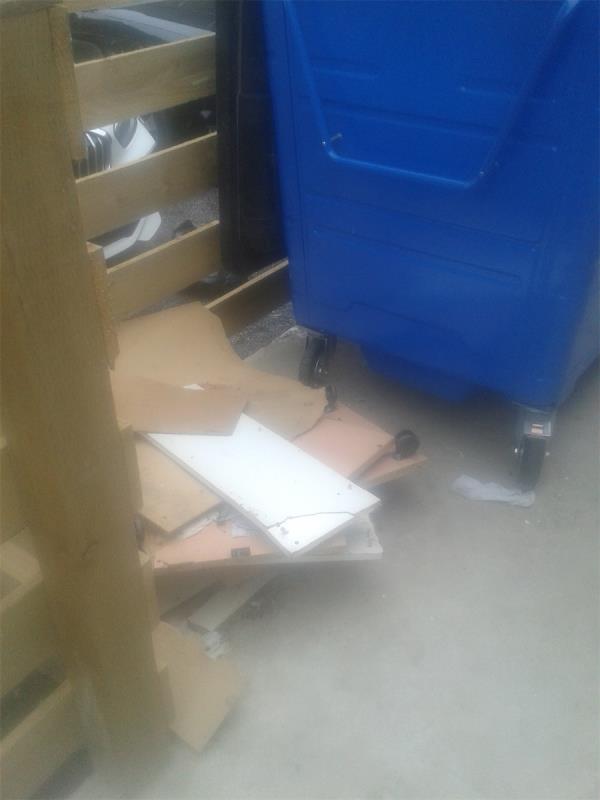 Please clear flytip of wood from by refuse bins of hostel -5 Baring Road, London, SE12 0JP