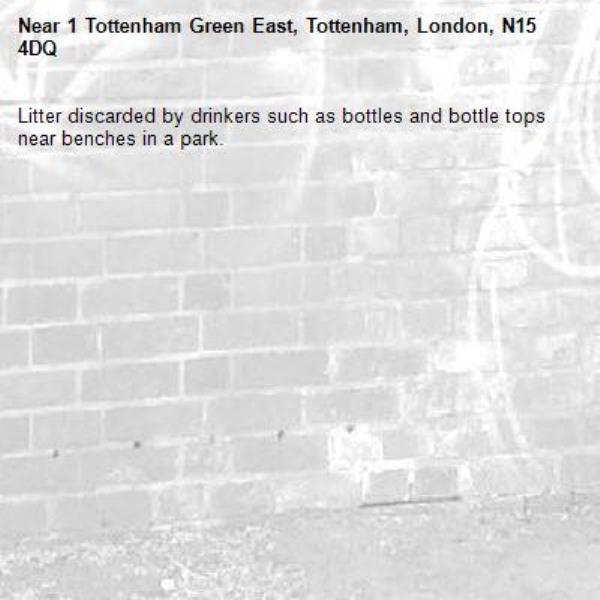 Litter discarded by drinkers such as bottles and bottle tops near benches in a park.-1 Tottenham Green East, Tottenham, London, N15 4DQ
