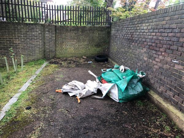 By side of Railway Bridge and Florence  Garden. Please clear a grab bag and other waste-50 Florence Terrace, London, SE14 6TU