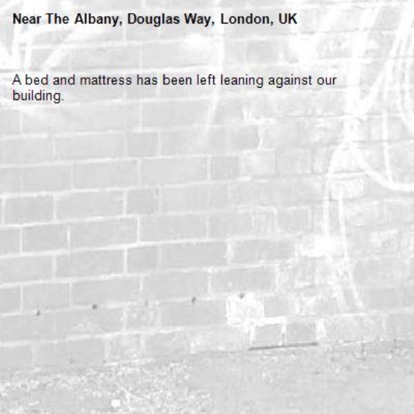 A bed and mattress has been left leaning against our building.-The Albany, Douglas Way, London, UK