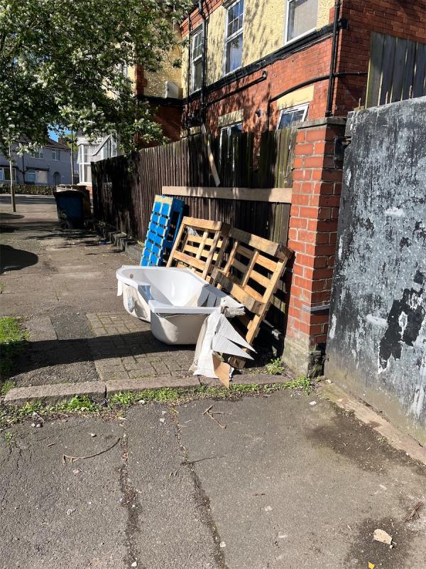Pallets, and old bath, just the usual stuff that’s regularly dumped here. 

It’s to the side of the house on the corner of lavender rd & imperial ave, adjacent to 33 lavender rd. -33 Lavender Road, Leicester, LE3 1AL