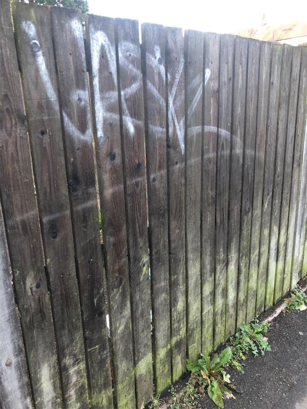 Side of no 60. Remove graffiti from wooden fence on Lion Close-52 Henry Cooper Way, Grove Park, London, SE9 4JF