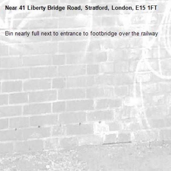 Bin nearly full next to entrance to footbridge over the railway -41 Liberty Bridge Road, Stratford, London, E15 1FT