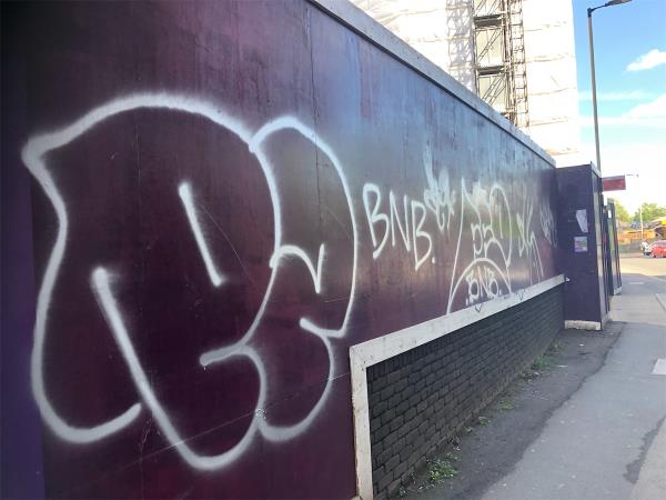 Remove graffiti from development site haulding at the Tustin Estate-321-343 Ilderton Road, London, SE15 1NW