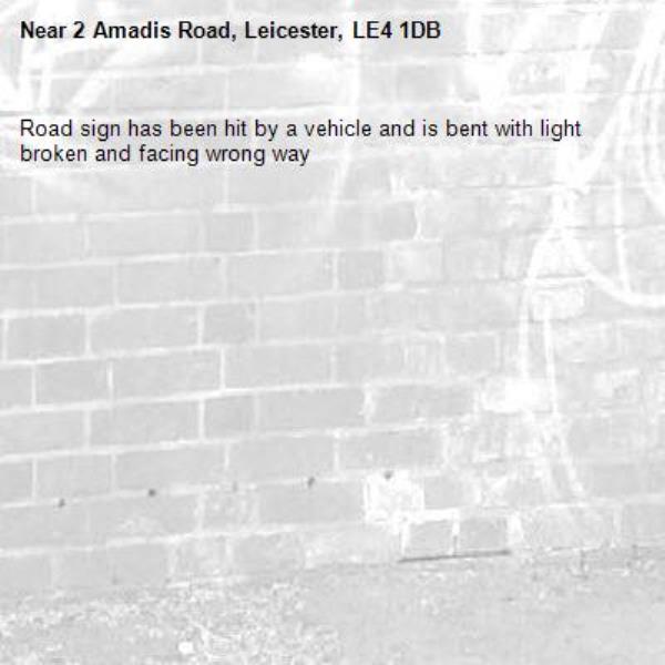 Road sign has been hit by a vehicle and is bent with light broken and facing wrong way-2 Amadis Road, Leicester, LE4 1DB