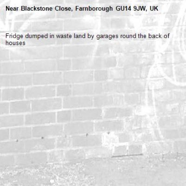 Fridge dumped in waste land by garages round the back of houses -Blackstone Close, Farnborough GU14 9JW, UK