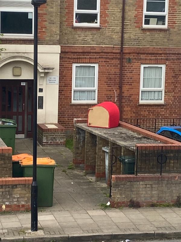 Big red chair dumped on the bins -141 Memorial Avenue, Stratford, London, E15 3BS