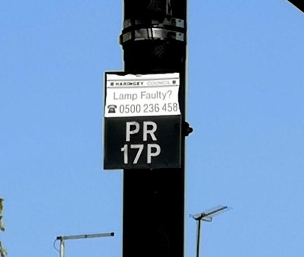 Street light on by day. -Service Road From Park Road To Kelland Close, London