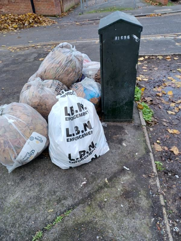 Bags of household waste fly tipped next to Street cleaners Bags at junction of 33 Doherty Road and Chargeable Lane, E13. -33 Doherty Road, Plaistow, London, E13 8DR