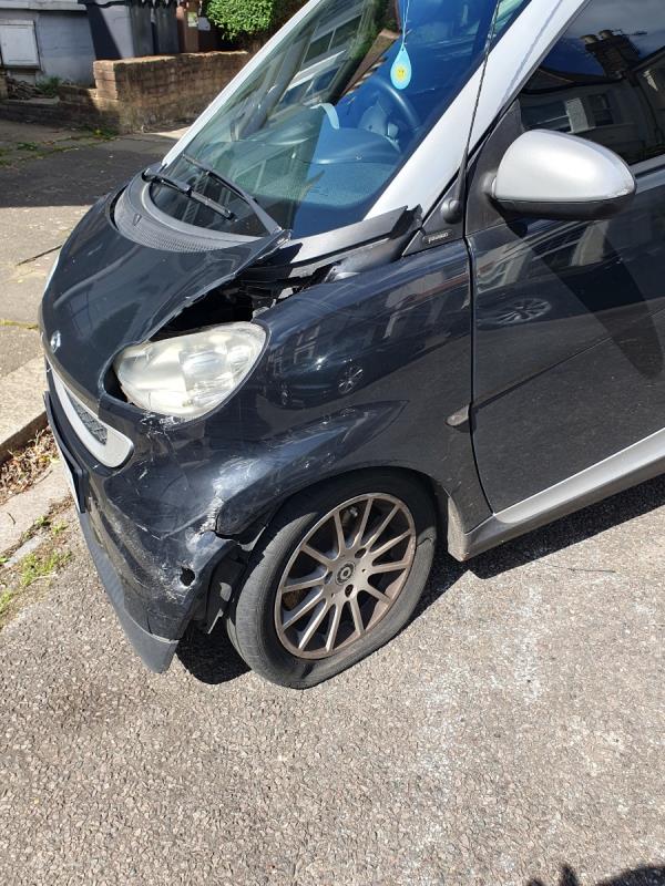 Smart car, flat tyre & smashed front.  I saw someone leave the car last week and drive off in a white car reg -Flat A, 176 North View Road, Hornsey, London, N8 7NB