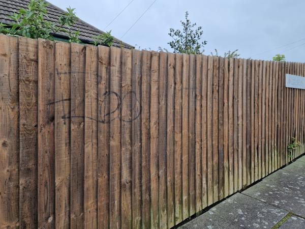 There's graffiti on the wooden fence. Please resolve this issue.-Amersham Road, Leicester