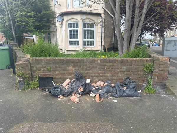 Bags full of what appears to be bricks dumped on the pavement. -117 Courthill Road, Hither Green, London, SE13 6DW