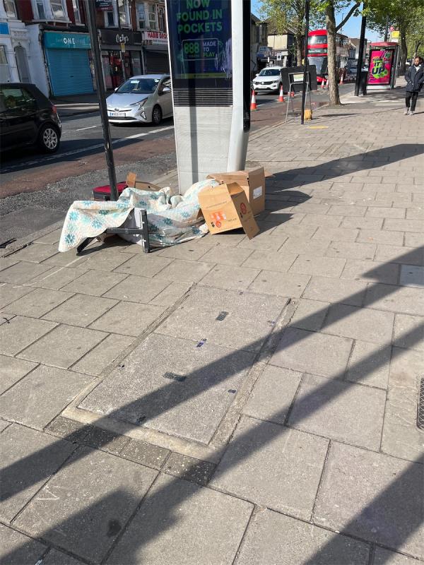 Various items and cardboard boxes dumped by roadside.-Rions Naan And Chai, 291 Barking Road, East Ham, London, E6 1LB