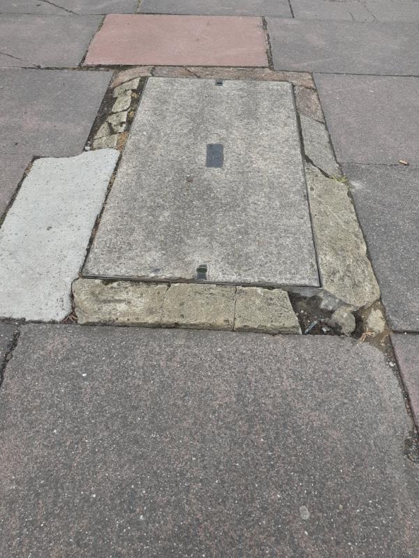 Man hole cover is quite raised but edging is very uneven. Nearby paving slabs damaged and dibbed. Both quite a trip hazard. -90 Chesswood Road, Worthing, BN11 2AG