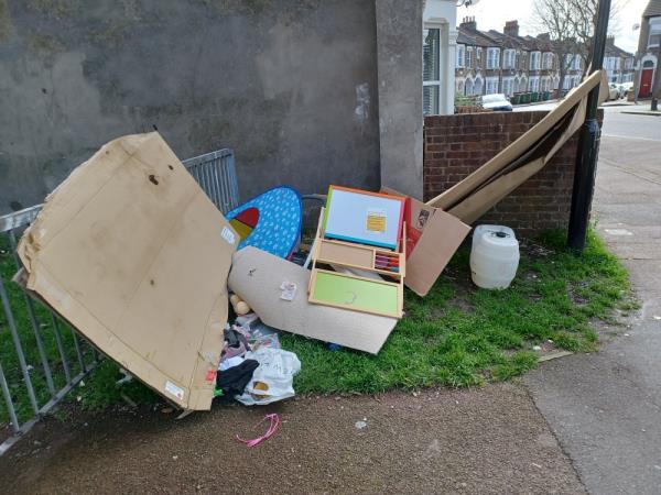 Cardboard boxes, plastic containers, toys, rug items of clothing fly tipped at corner of 83 Carson Road, E16. -83 Carson Road, Canning Town, London, E16 4BD