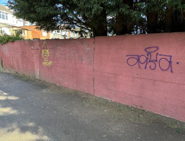 Graffiti/Tagging on garden wall running alongside lane outside school gates from Knighton Lane East to Pendlebury Drive.-181 Knighton Lane East, Leicester, LE2 6FU