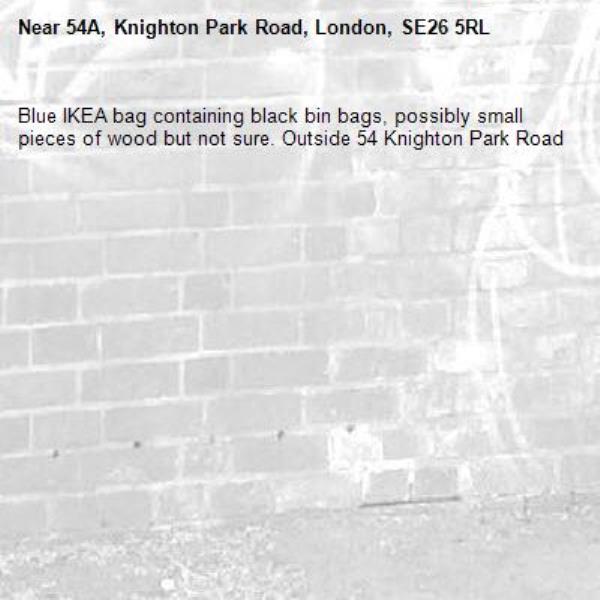 Blue IKEA bag containing black bin bags, possibly small pieces of wood but not sure. Outside 54 Knighton Park Road-54A, Knighton Park Road, London, SE26 5RL