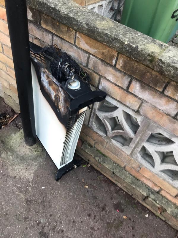 Dangerous item. Burnt out electric heater dumped as well as other household items nearby. Concerned how this catching fire could have resulted in a bigger fire.-28 Northfield Road, East Ham, E6 2AJ