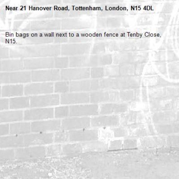 Bin bags on a wall next to a wooden fence at Tenby Close, N15.-21 Hanover Road, Tottenham, London, N15 4DL