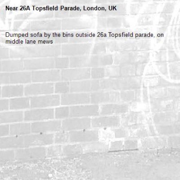 Dumped sofa by the bins outside 26a Topsfield parade, on middle lane mews-26A Topsfield Parade, London, UK