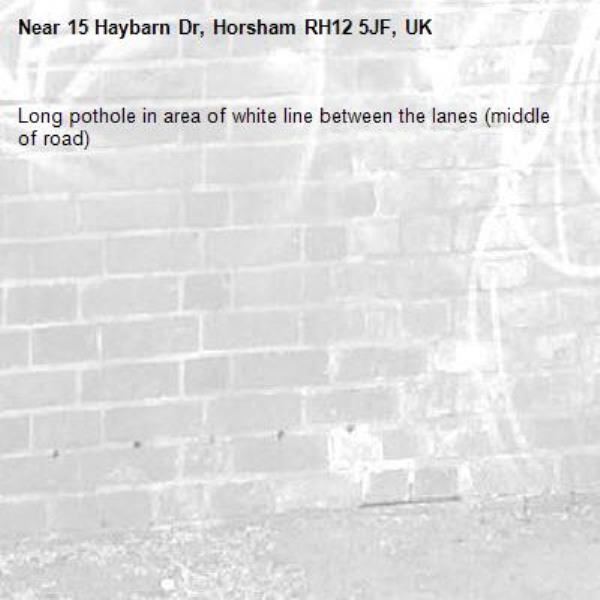 Long pothole in area of white line between the lanes (middle of road) -15 Haybarn Dr, Horsham RH12 5JF, UK