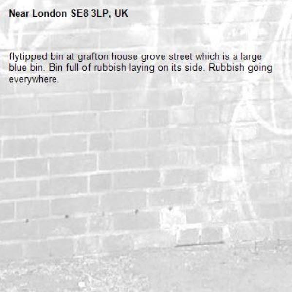 flytipped bin at grafton house grove street which is a large blue bin. Bin full of rubbish laying on its side. Rubbish going everywhere.-London SE8 3LP, UK