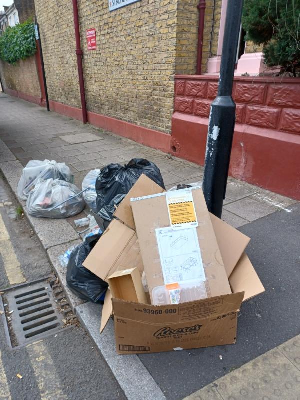 Cardboard boxes, items of clothing and household waste fly tipped at junction of 144 Shrewsbury Road and Strone Road, E7. -144 Shrewsbury Road, Forest Gate, London, E7 8QB