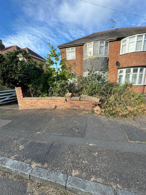 There has been a wall knocked down which is spilling over onto the pavement causing an issue with loose brickwork. Dangerous and hazardous as the wall can collapse at any moment -84 Cardinals Walk, Leicester, LE5 1LF