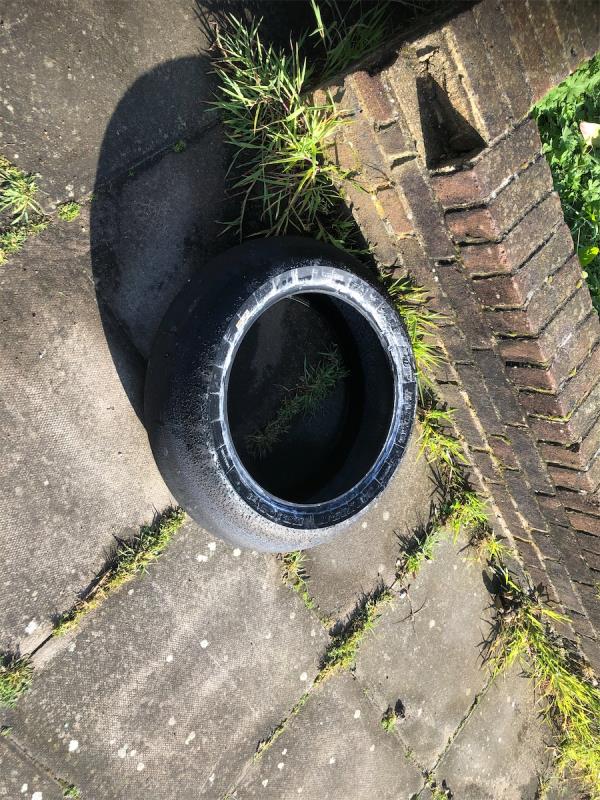 WG Grace Square. Please clear a dumped tyre-66 Henry Cooper Way, Grove Park, London, SE9 4JG