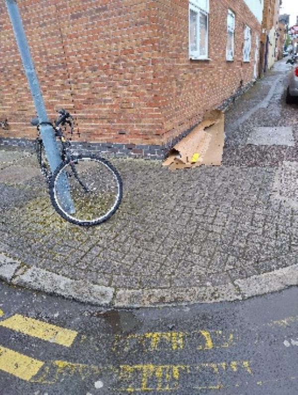 cardboard, a rubbish bag and a bicycle abandoned on the corner of osmaston road and rowsley street -38 Rowsley Street, Leicester, LE5 5JL