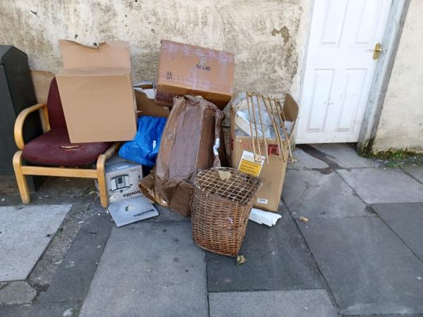Cardboard boxes, chair, basket and wooden boards fly tipped at junction of 150 Green Street and Cheshunt Road, E7. -150A, Green Street, Forest Gate, London, E7 8JQ