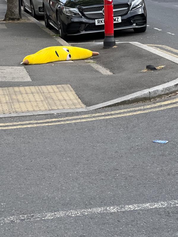Giant orange toy banana left on boundary Road near Wilson Road-77 Boundary Road, Plaistow, London, E13 9PS