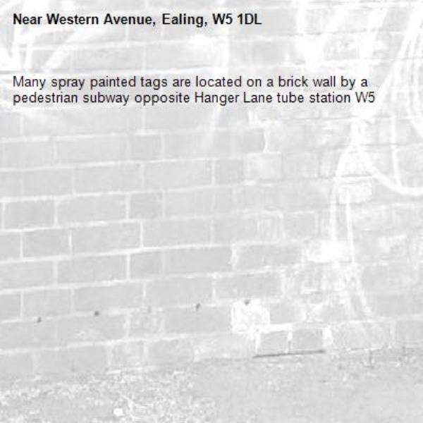 Many spray painted tags are located on a brick wall by a pedestrian subway opposite Hanger Lane tube station W5 -Western Avenue, Ealing, W5 1DL