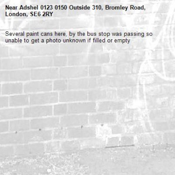 Several paint cans here, by the bus stop was passing so unable to get a photo unknown if filled or empty-Adshel 0123 0150 Outside 310, Bromley Road, London, SE6 2RY