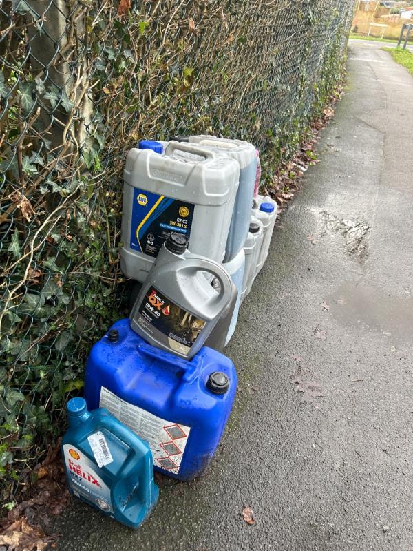 These containers have been here for about seven days and I believe they may already have been reported. As they contain unknown liquids these must be removed AS SOON AS POSSIBLE!  Reported here by Cllr Taylor. -2 The Grove, Farnborough, GU14 6QR