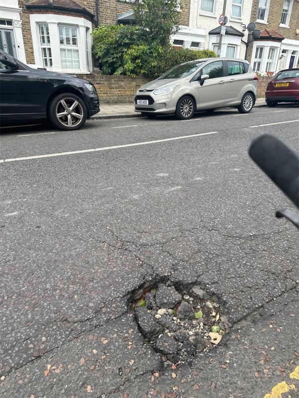 Large pothole -97 Beechcroft Road, London, SW17 7BP
