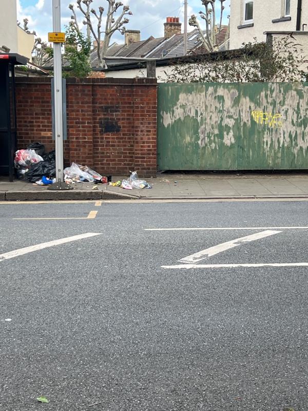 Multiple bin bags of household waste split and spinning onto the street. This is located at bus stop U on Central Park Road.-5 Hatherley Gardens, East Ham, London, E6 3EN
