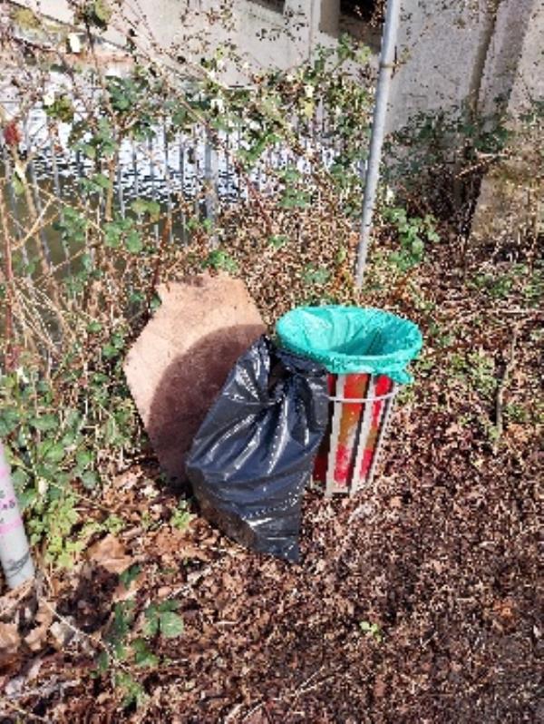 rubbish dumped by litter bin -The Riverside, 206 Caversham Road, Reading, RG1 8AZ