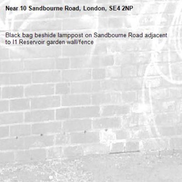 Black bag beshide lamppost on Sandbourne Road adjacent to I1 Reservoir garden wall/fence-10 Sandbourne Road, London, SE4 2NP
