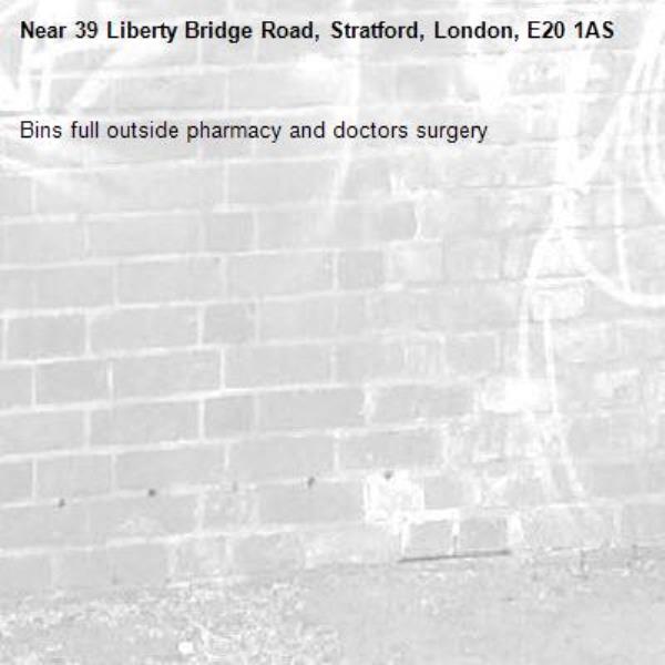 Bins full outside pharmacy and doctors surgery -39 Liberty Bridge Road, Stratford, London, E20 1AS