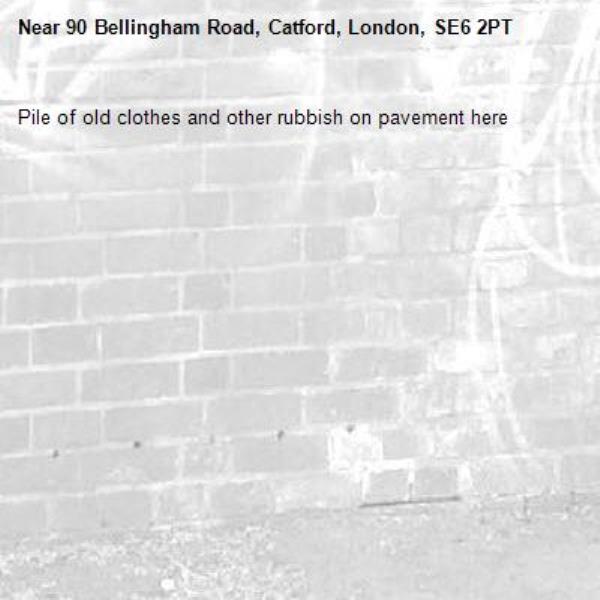 Pile of old clothes and other rubbish on pavement here -90 Bellingham Road, Catford, London, SE6 2PT
